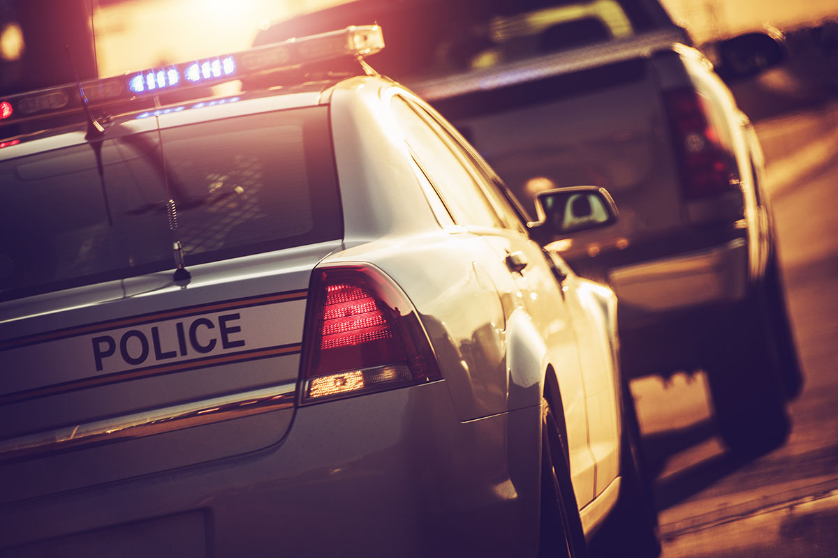 State Police Traffic Stop on a Highway. Police Cruiser with Flashing Lights.